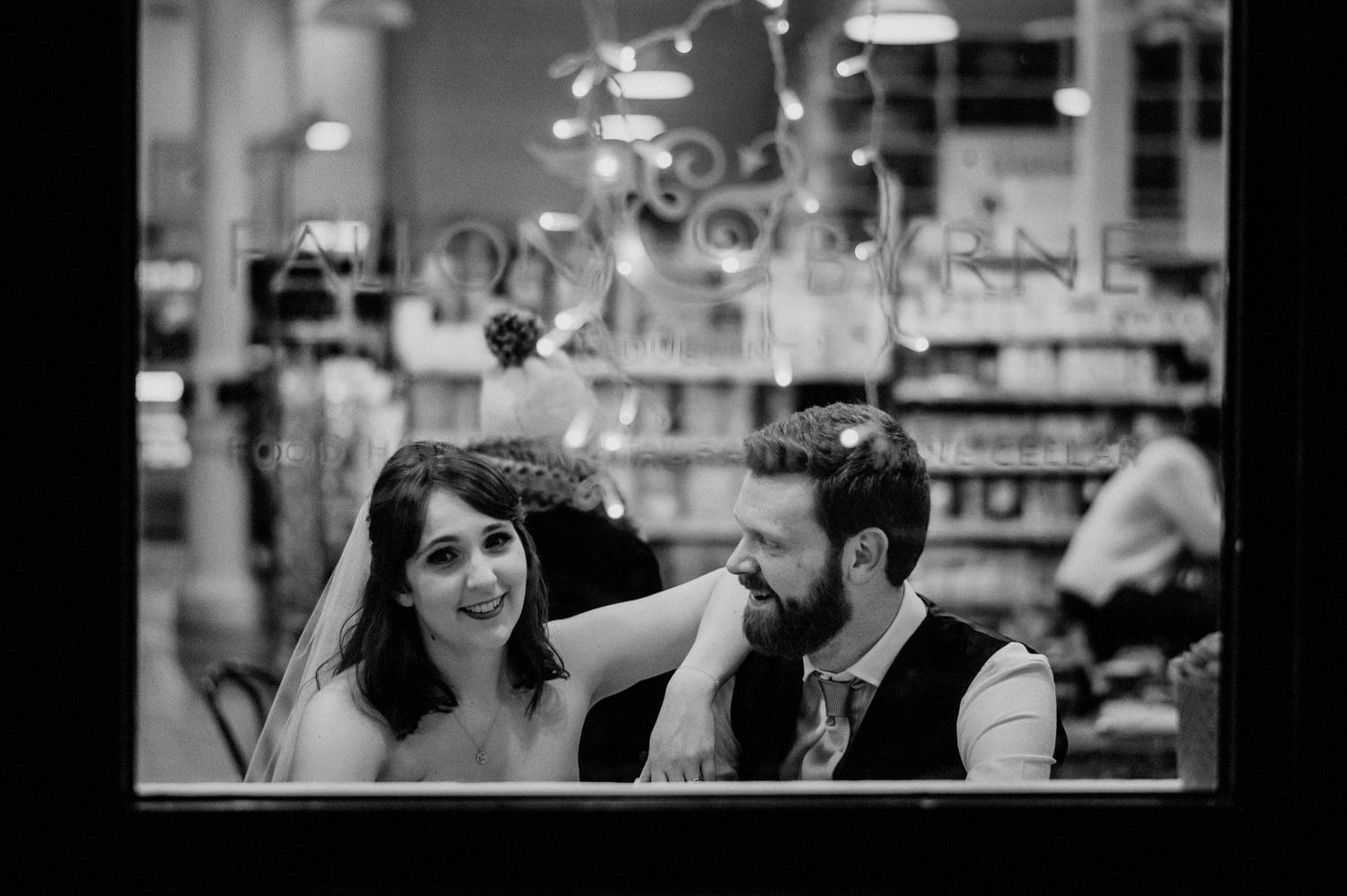 wedding couple relaxing by window of Fallon & Byrne restaurant. 
