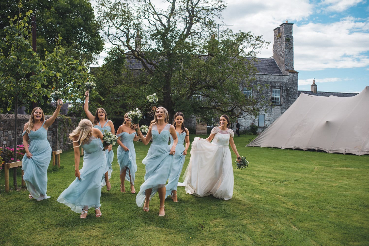 Bridal party having fun at the gardens of Durhamstown Castle during a wedding. 