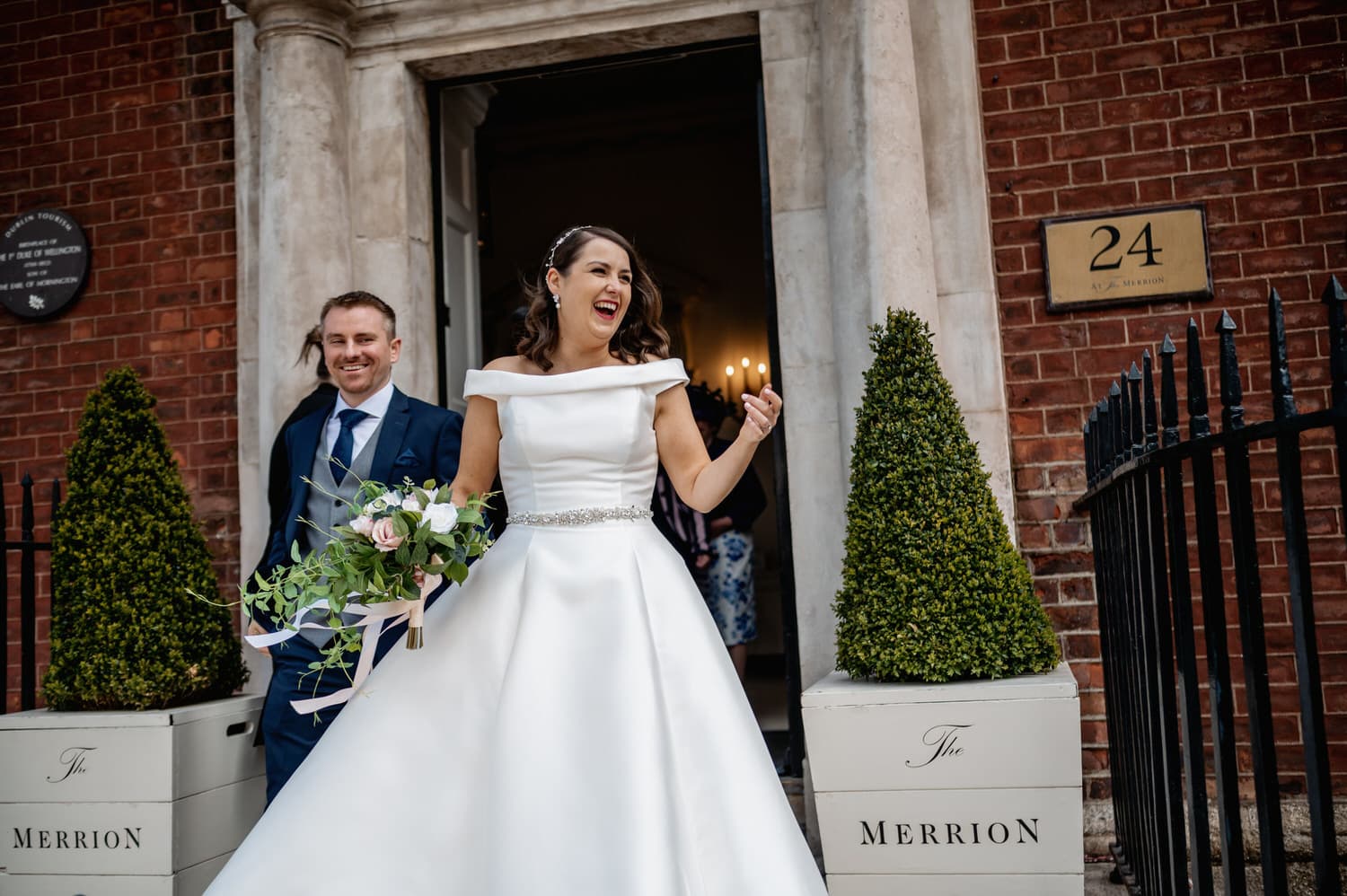 Laughing bride exiting the Merrion Hotel